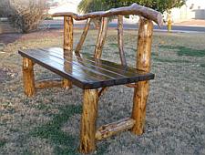 Bench frame from branches and seat made from scaffold boards.