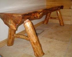 Coffee table made from a halved tree trunk and branches for the legs.