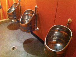 Three urinals made with recycled beer barrels.