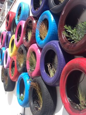 Repurposed and reclaimed tires in use as a wall garden.